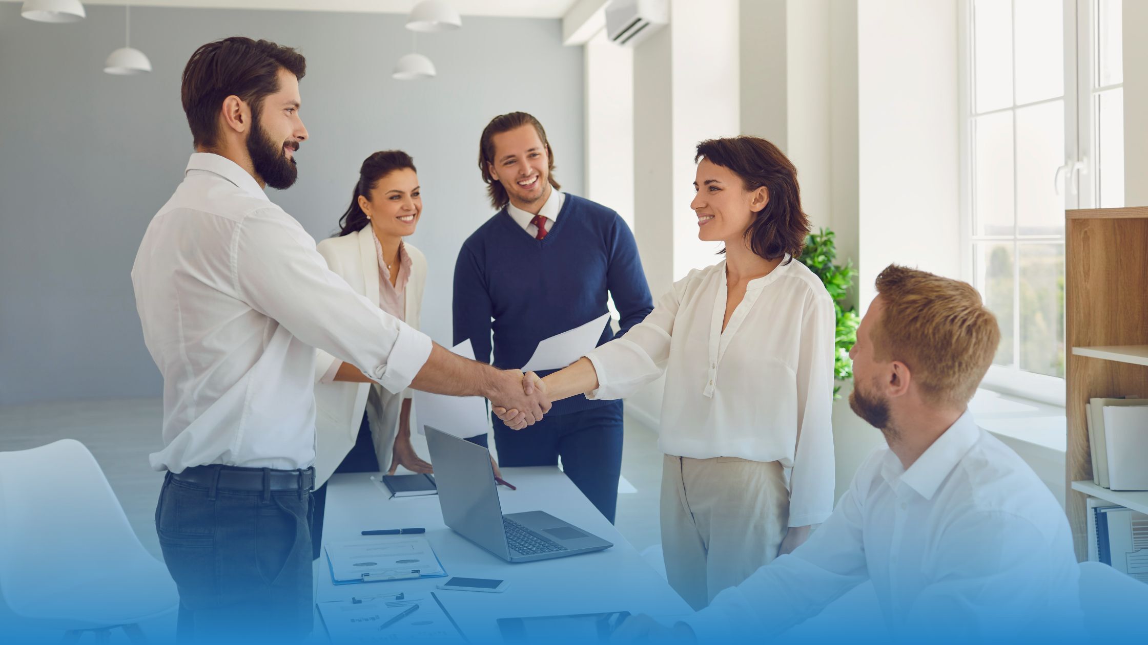 Business professionals shaking hands after successful NDA negotiation, symbolizing trust, fairness, and standardized contracts with TermScout.