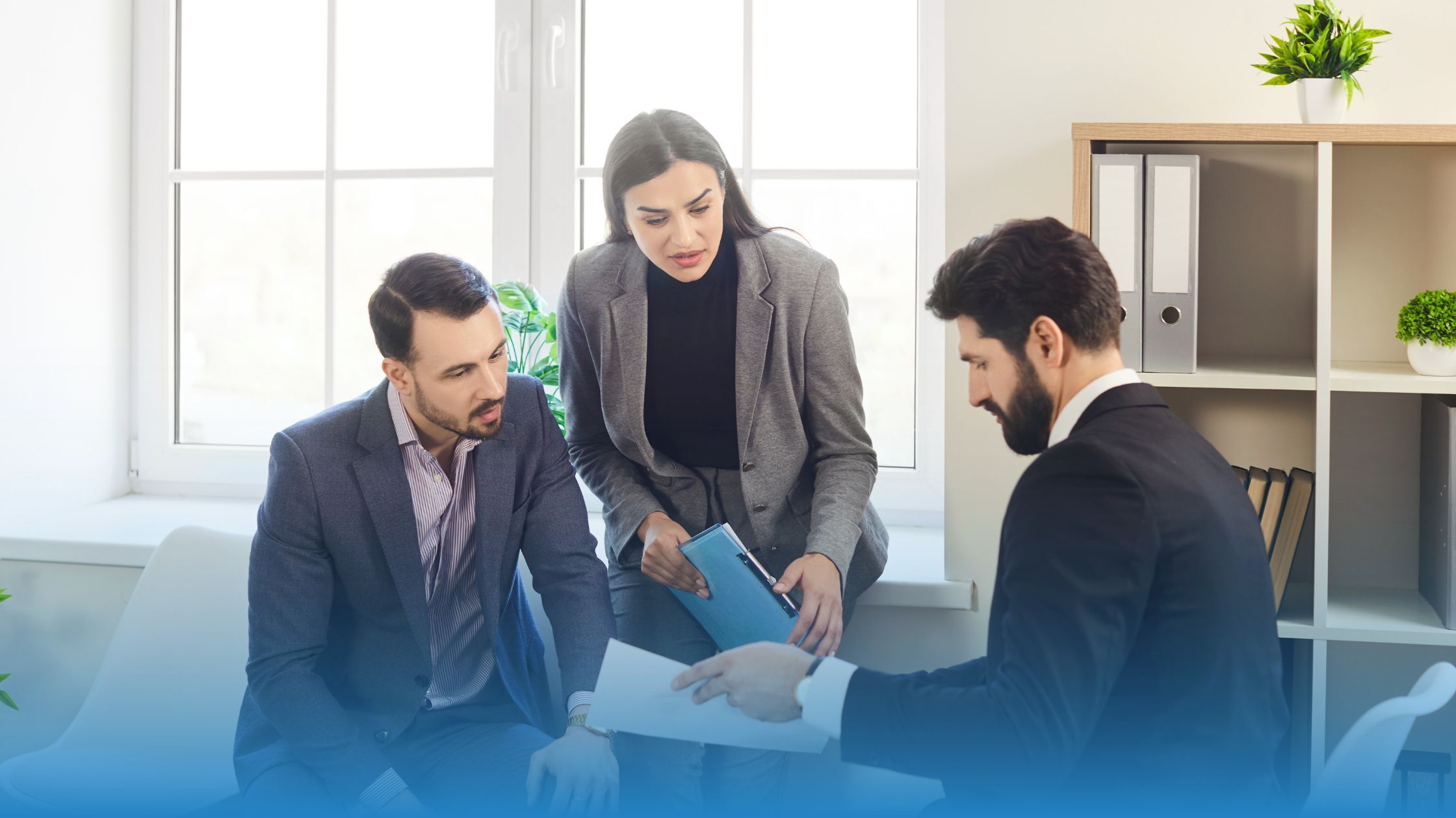 Three professionals discussing contract terms to improve clarity and reduce delays.