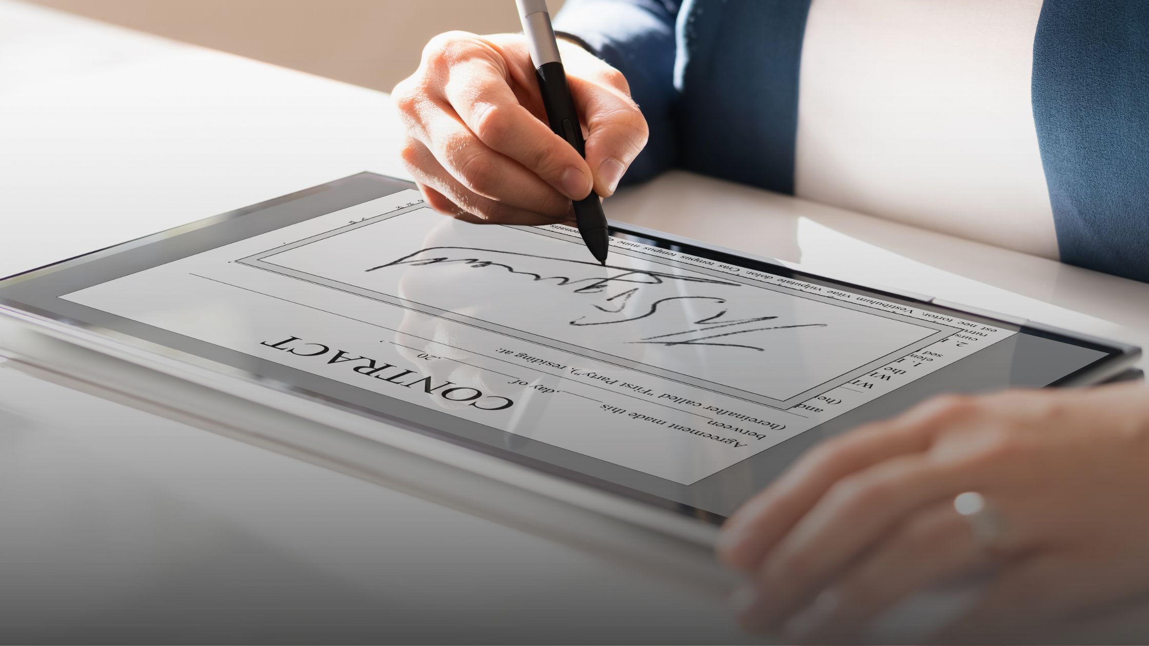 Business professional signing a digital contract on a tablet, symbolizing streamlined contract data analysis and execution