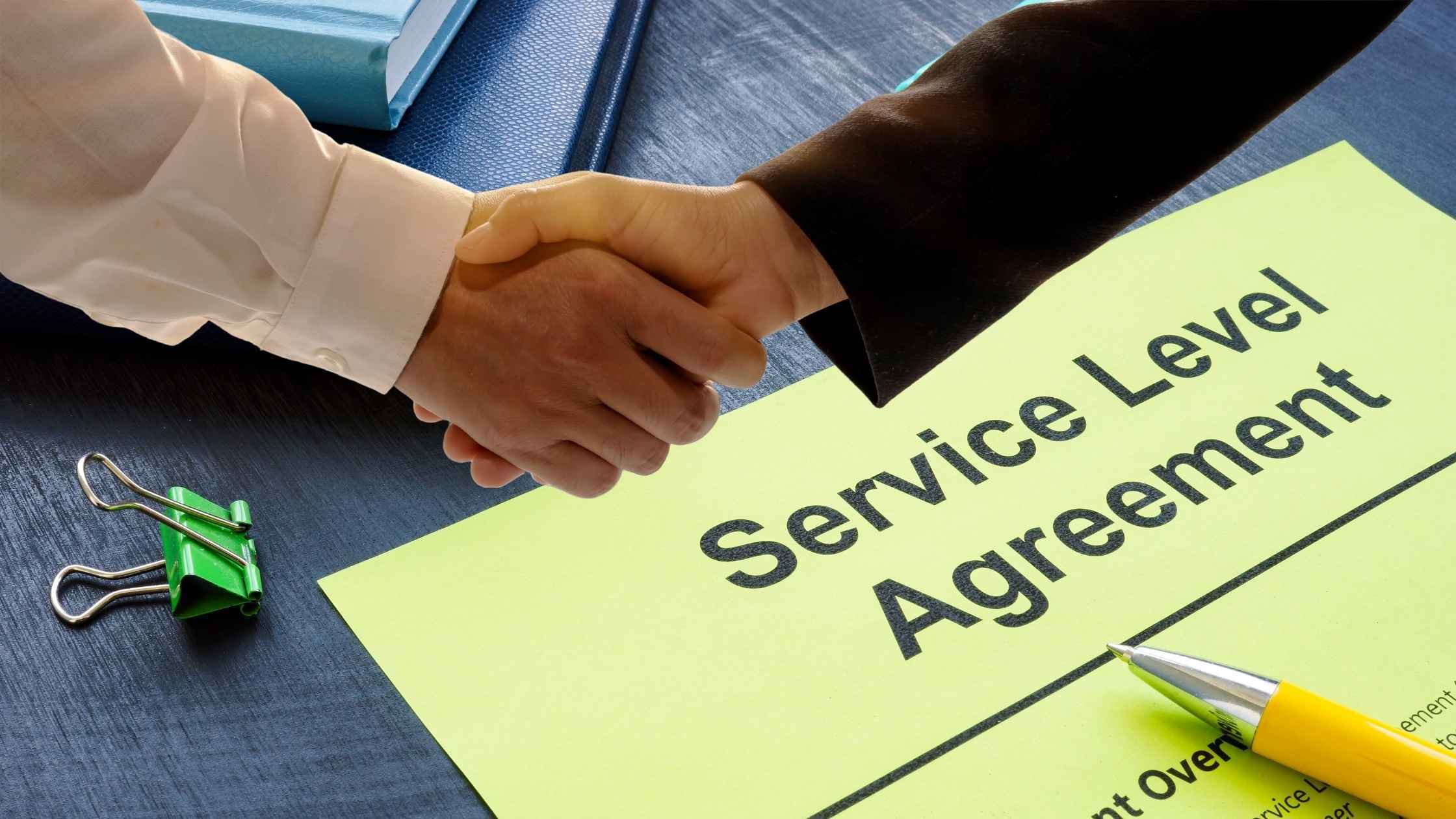 Handshake over an SLA document labeled “Service Level Agreement”